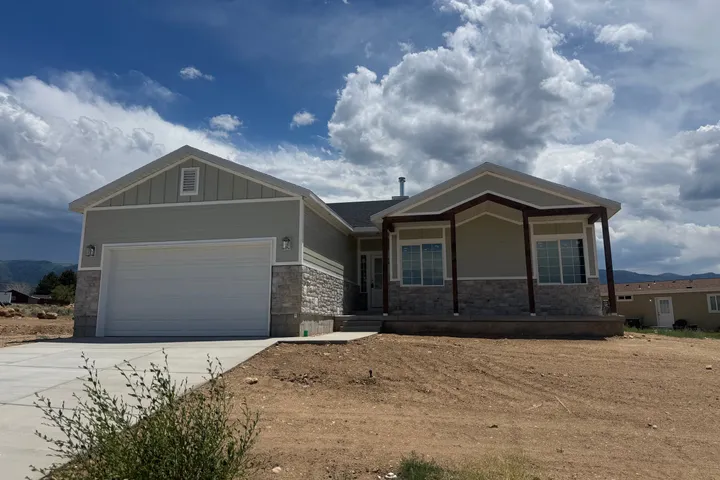 The finished single-story home with stone accents and a two-car garage in Mt. Pleasant, Utah