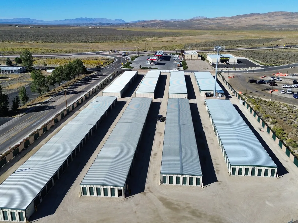 Rows of storage buildings at Citadel Spring Creek with mountains behind